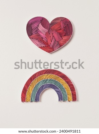 Paper heart and rainbow on white background. Happy valentine day, peace, LGBTQ+ community and love concept. symbol of community modern flat design peace sign. Hand made of paper quilling technique. 
