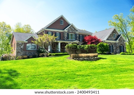 House in suburb in North America. Luxury houses with nice landscapes. Royalty-Free Stock Photo #2400493411