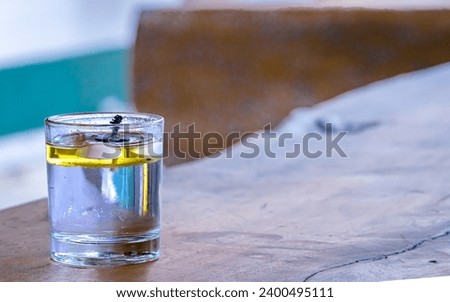 Chilled cocktail in a glass with ice and water droplets.