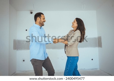 Wife and husband millennial couple dancing celebrating moving day at new first own dwelling feels happy, living together cohabitation, life changes concept