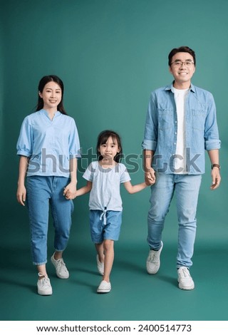 Photo of young Asian family on background