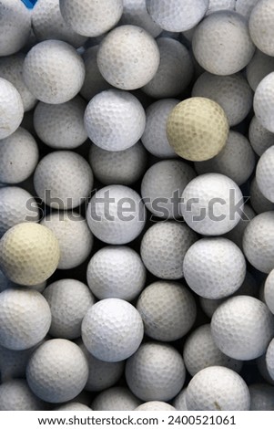 Top view photo of a bunch of golf balls in white colour all togethe rin pile stack in a basket in a golf court during a training lesson course for sportive to practice and improve their skills