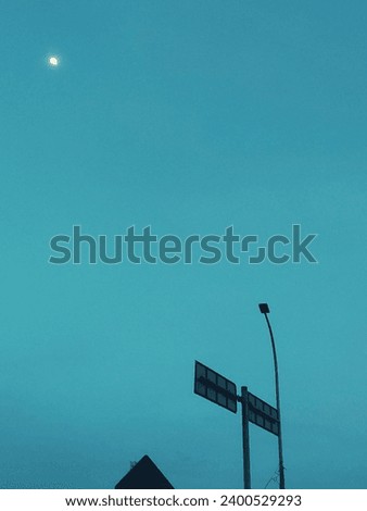 street sign with street lights at dawn