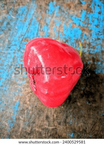 red rose aplle fruit with isolated on blue wooden table background