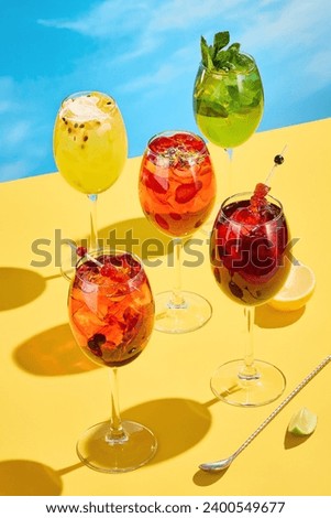 A collection of vibrant summer cocktails against a blue sky, perfect for a sunny day's refreshment. Royalty-Free Stock Photo #2400549677