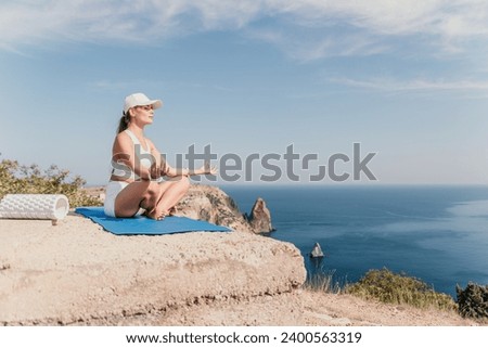Fitness woman sea. Outdoor workout on yoga mat roller in park near to ocean beach. Female fitness pilates yoga routine concept. Healthy lifestyle. Happy fit woman exercising with rubber band in park.