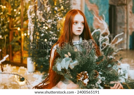 red haired beautiful young woman in white dress and crown lies in loft room among decorated fir branches with twinkle lights, diverse people, Christmas and New Year celebration