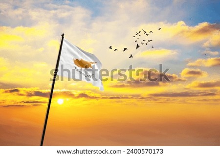 Waving flag of Cyprus against the background of a sunset or sunrise. Cyprus flag for Independence Day. The symbol of the state on wavy fabric.