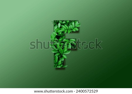 Leaf font F isolated on white green gradient background. Leafs font F made of Real alive leaves with Previous paper cut shape of font. Green climate concept.
