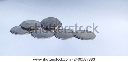 thousand rupiah coins with angklung motif on white background 