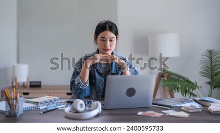 Graphic designer women read data on laptop to thinking and working designing about graphic design.