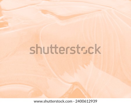 Trendy color of 2024 Peach Fuzz. Natural ice texture. Abstract natural background toned in color of year 2024. Selective focus, blur. Space for text. Top View Royalty-Free Stock Photo #2400612939