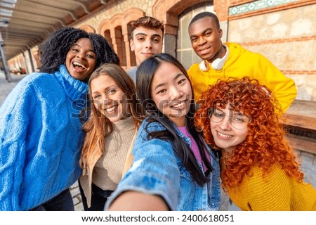 Personal perspective of a chinese girl and diverse friends taking a selfie outdoors