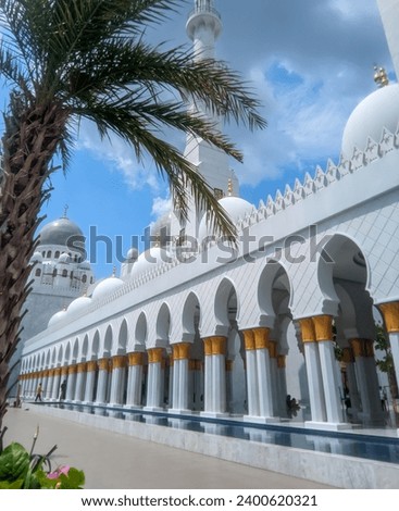 The large building of the Syech Zayed Solo Mosque looks clear against the sky and trees in the mosque yard  Royalty-Free Stock Photo #2400620321