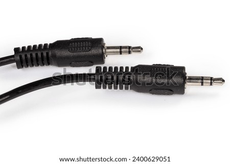 Stereo connectors mini jack on the edges of the analog audio cable on the white background close-up 
 Royalty-Free Stock Photo #2400629051