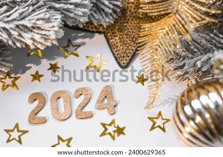Banner. Happy New Year and Merry Christmas. Golden numbers 2024, snow, fir branches and Christmas tree toys on a white background. The flyer. Invitation.