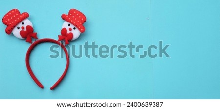 cute Christmas headbands with snowman's isolate on a blue backdrop. concept of joyful Christmas party,New year is coming soon, festive season decoration with Christmas elements
