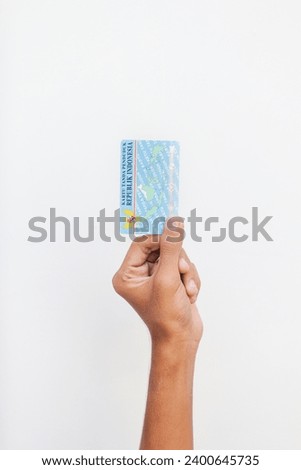 hand holding Indonesian identity cards or E-KTP ( Kartu Tanda Penduduk ) owned by Indonesian citizens  Royalty-Free Stock Photo #2400645735