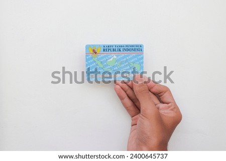 hand holding Indonesian identity cards or E-KTP ( Kartu Tanda Penduduk ) owned by Indonesian citizens  Royalty-Free Stock Photo #2400645737