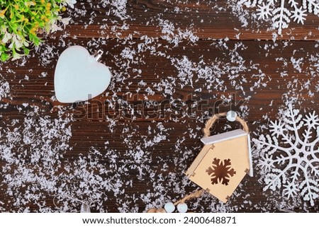 New Year's card on a wooden background.Christmas balls are toys.the glove of Santa Claus.santa claus.Snowflake.Birdie.A branch of a Christmas tree.festive background, place for text.BANNER