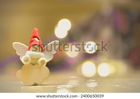 Little winged Christmas elf, sitting on a customizable wooden cloud, against a bokeh background.