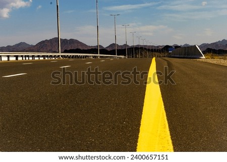 On this winding road of solitude I tread.   A journey long, where dreams are led. Royalty-Free Stock Photo #2400657151