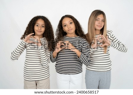 Serious multi racial group of girl friends keeps hands crossed stands in thoughtful pose concentrated somewhere