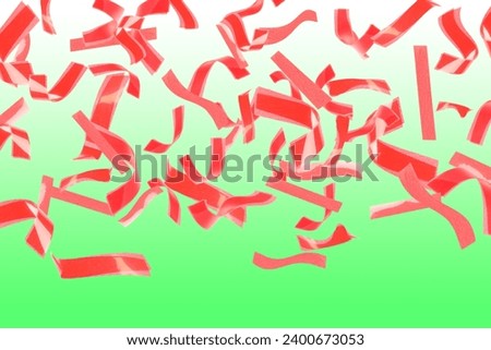 Bright red confetti falling on gradient green background