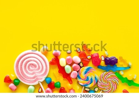Flat lay of colorful candies and lollipop. Sweet food and candies background. Royalty-Free Stock Photo #2400675069