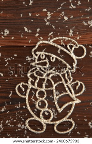 The snowman. New Year's card on a wooden background.Christmas balls are toys..santa claus.The snowflake of the Christmas tree.festive background, place for text.the banner