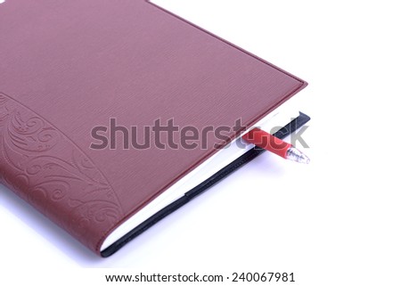 Book Bookmarked with red pen On White Background