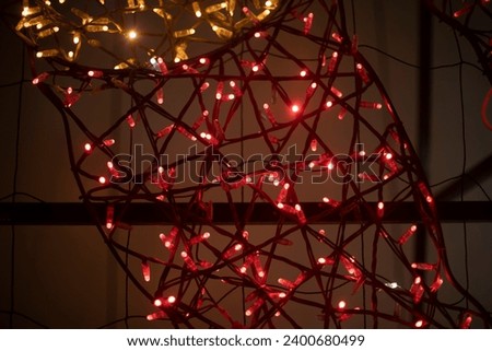 Garlands on street at night. Decoration of city. Structure is decorated with garlands; . Lots of small light bulbs.