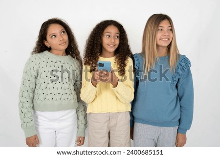 multi racial group of girl friends  hold telephone hands read good youth news look empty space advert