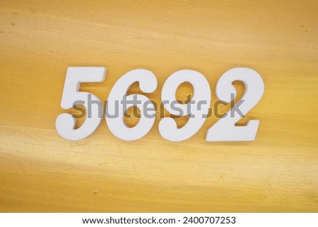 The golden yellow painted wood panel for the background, number 5692, is made from white painted wood.