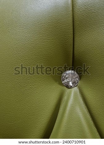 Button on the bed, diamond button, green army background