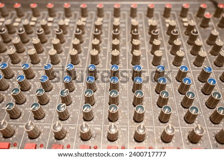 Close up of audio mixer board. Professional multitrack mixing console. Equipment in studio.