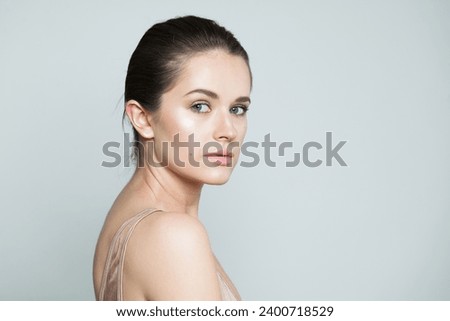 Beautiful fashion beauty model brunette with clear skin and dark hair. Beautiful young female face closeup portrait