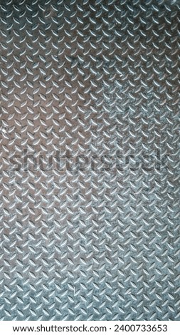 Abstract photograph with texture of stainless steel sheet, steel plate, non-slip used in industrial plants.

