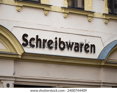Schreibwaren (stationery) sign of a shop in Germany. The lettering is on the facade of the building. Retailer for writing materials like pens and paper in the city. Store for office supply.