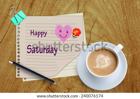  Happy Saturday word and coffee cup on wooden background.