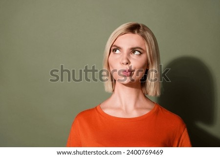 Photo portrait of attractive young woman look skeptical empty space wear trendy orange clothes isolated on khaki color background Royalty-Free Stock Photo #2400769469