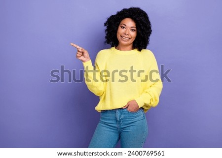 Photo portrait of lovely young lady pointing poster empty space dressed stylish yellow garment isolated on violet color background