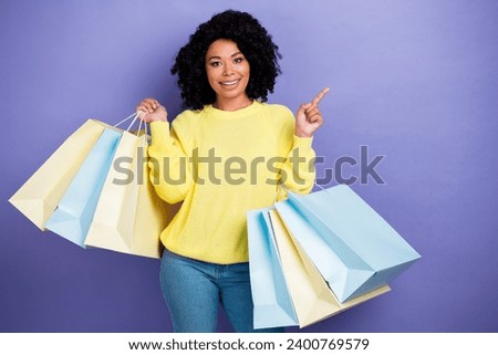 Photo portrait of lovely young lady shopping point empty space dressed stylish yellow garment isolated on violet color background