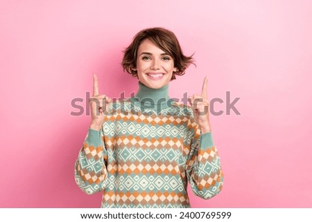 Photo of positive lovely person beaming smile direct fingers up empty space isolated on pink color background