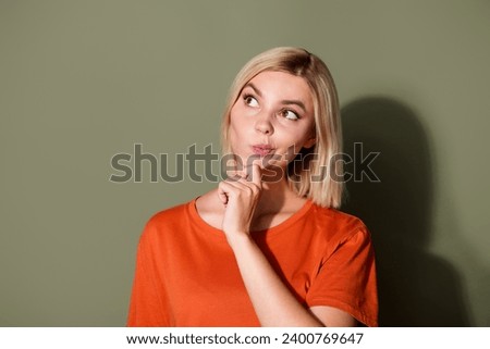 Photo portrait of attractive young woman look interested empty space dressed stylish orange clothes isolated on khaki color background Royalty-Free Stock Photo #2400769647