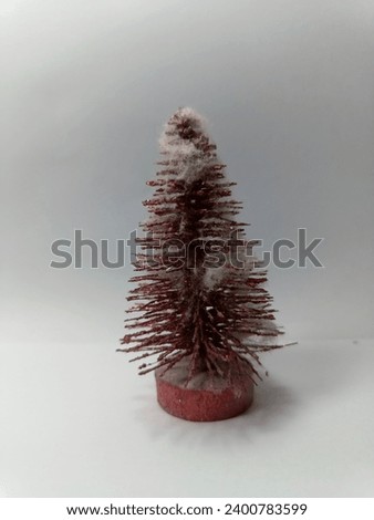 Red Christmas tree with cotton as fake snow decorations
