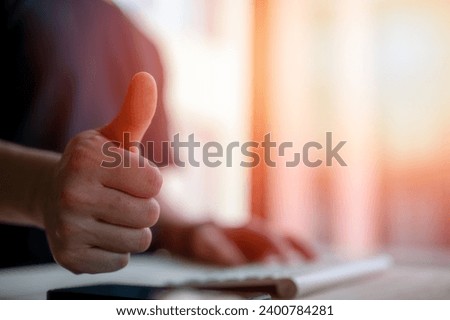 closeup shot of businessman showing thumbs up in business success and high performance