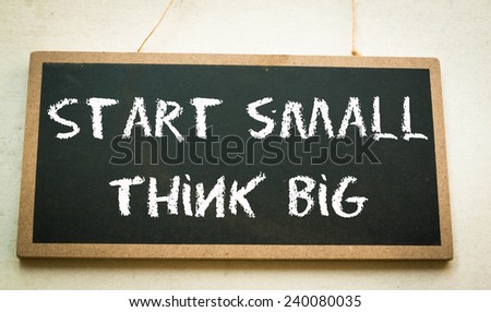 Start small think big text write on wall 