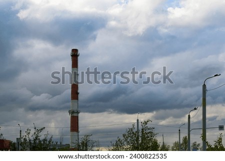 Boiler room pipe and street lights on the background of picturesque rain clouds