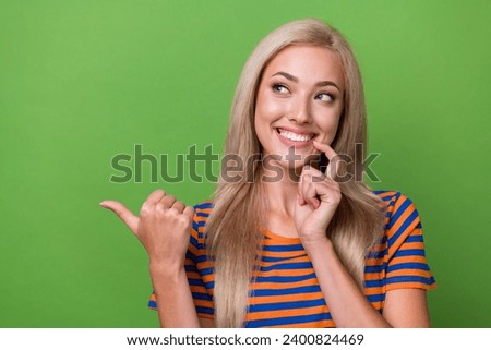 Photo of lovely cute girl wear trendy clothes touch face look empty space interesting proposition isolated on green color background